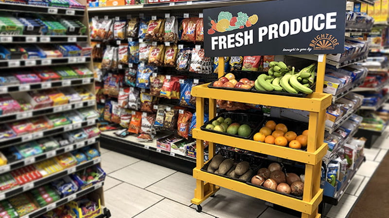 A BrightSide fresh produce stand on a convenience store candy and snack aisle A BrightSide fresh produce stand on a convenience store candy and snack aisle
