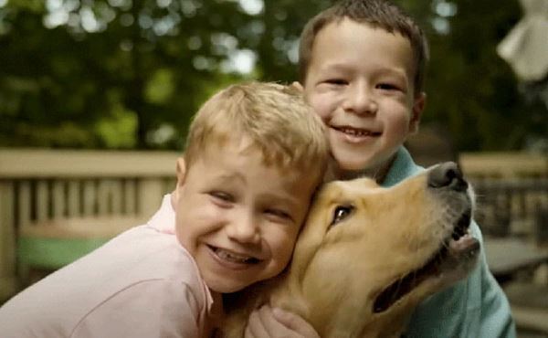 Finn Kelly and his brother hug their dog Finn Kelly and his brother hug their dog
