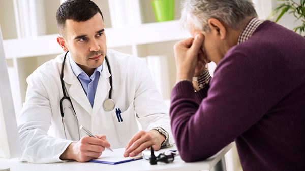 worried older man talking to doctor worried older man talking to doctor